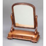 A Victorian arched plate dressing table mirror contained in a mahogany frame, the rectangular base