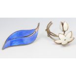 A Norwegian silver and blue guilloche enamel scroll brooch 55mm and a white enamelled ditto with