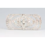 An 18ct white gold Art Deco diamond brooch set with 5 graduated old cut diamonds and rose cut