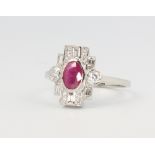 A platinum ruby and diamond cluster ring in the Edwardian style, the ruby approx. 0.65ct the