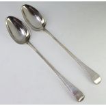 A pair of George III silver basting spoons with beaded decoration and armorials London 1811, 246