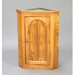 A Victorian style pine corner cabinet with arched panelled door and moulded cornice 63cm h x 44cm