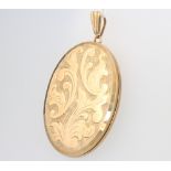 An oval 9ct yellow gold engraved locket 14 grams gross, 43mm