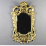 A Victorian oval shaped bevelled plate mirror contained in a pierced gilt metal Rococo style frame