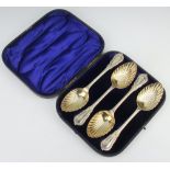 A cased set of 4 Victorian silver lily pattern serving spoons with gilt bowls London 1889, 392