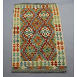 A cream, yellow and green Chobi Kilim rug with all over geometric design 126cm x 80cm