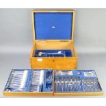 An Edwardian oak canteen containing silver plated lily pattern cutlery (106)
