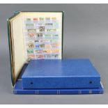 A green stock book of used GB and colonial stamps, a blue ring bind album of Elizabeth II mint and
