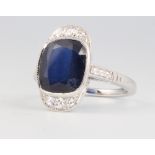 An 18ct white gold sapphire and diamond cocktail ring, the sapphire approx 5ct surrounded by