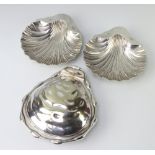 A pair of Edwardian silver shell butter dishes London 1908, 158 grams together with a plated ditto