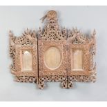 A 19th Century Burmese carved and pierced hardwood triptych photograph frame surmounted by a