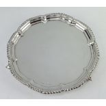 A silver salver with pie crust rim on scroll feet, Sheffield 1942, 21cm, 304 grams