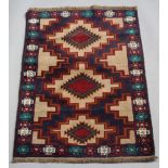 A brown, blue and green ground Belouche rug with 3 stylised medallions to the centre 135cm x 86cm