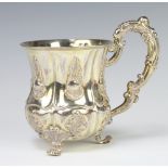 A 19th Century Continental repousse silver baluster mug with fancy scroll handle 233 grams, 13cm