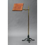 A Victorian mahogany brass and iron adjustable music stand, raised on paw feet 120cm h x 33cm w x