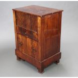 A 19th Century Continental mahogany commode with cupboard enclosed by a tambour shutting above 1