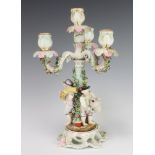 A 19th Century German 4 light candelabrum, the base with 3 figures 34cm Several flowers are chipped