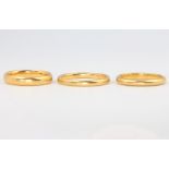 Three 22ct gold wedding bands size L, L 1/2 and P, 10.4 grams