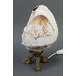 A Victorian carved conch shell decorated Old Father Time, raised on dolphin gilt metal supports 28cm