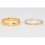 A platinum and 22ct gold wedding band 0.8 grams, size J 1/2 together with a 22ct gold wedding band
