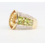 A 9ct yellow gold peridot and gem set ring 5.6 grams, size O