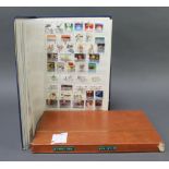 A stock book of Australian mint and used stamps, Victoria to Elizabeth II and a stock book of New