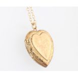 A 9ct yellow gold plated heart locket hung on a 9ct yellow gold chain 1 gram, 20cm