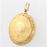 A 9ct yellow gold engine turned circular locket gross 3.9 grams 25mm