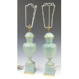 A pair of 20th Century Continental ceramic table lamps decorated classical figures on square bases
