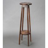 A 1930's circular oak 2 tier jardiniere stand raised on squared supports 100cm h x 26cm diam.