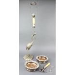 A pair of silver plated coasters, a ditto table lamp in the form of a heron, a ham holder and a pair