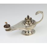 An Egyptian silver table oil lamp with serpent handle, 134 grams, 16cm