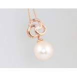 A 9ct rose gold natural pearl pendant set with diamonds on a 9ct rose gold chain, diamonds approx