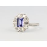 A platinum tanzanite and diamond cluster ring, the centre stone approx. 1.1ct, the brilliant and
