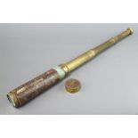 A 19th Century brass and leather 3 draw pocket telescopeThe leather covering to the main tube is