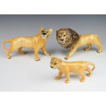 A Beswick group of a lion facing left no.2089, golden brown gloss 14cm, lioness facing right 2097,