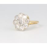 An 18ct yellow gold and platinum diamond daisy ring, approx. 1.75ct, size N, 15.4 gramsThe ring head