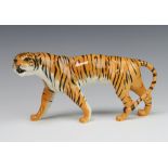 A Beswick figure of a tigress facing left, 1486 by Colin Melbourne, tan gloss 10.8cmThis lot has