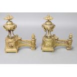 Two 19th Century right handed French pierced gilt metal Andirons (fire dogs) in the form of lidded