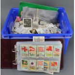 A blue crate of mixed cigarette cards