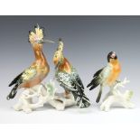 Karl Ens, a German figure of a bird standing on a trunk 17cm together with a pair of exotic birds