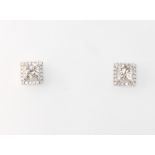 A pair of 18ct white gold princess cut halo diamond studs, the princess cut diamonds approx. 1.95ct,