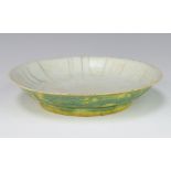 An 18th Century style Chinese yellow ground shallow dish decorated with dragons, having a 6