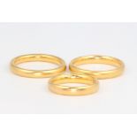 Three 22ct yellow gold wedding bands, sizes K, P and P, 15.5 grams