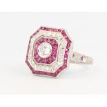 A Victorian style ruby and diamond octagonal dress ring, the brilliant cut diamond surrounded by