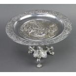 A Victorian circular chromium plated tazza decorated a classical scene, raised on scroll feet 18cm x