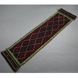 A green, blue and red ground Suzni Kilim runner with all-over diamond design 280cm x 76cm