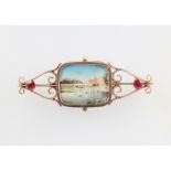 A yellow metal paste set bar brooch containing a painted ivory miniature of a riverscape, 70mm The