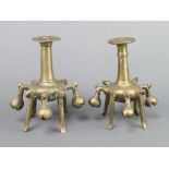 A pair of curious Eastern bronze candlesticks 13cm x 9cm