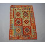 An orange, turquoise and green ground Chobi Kilim, the central ground formed of 6 rectangular panels